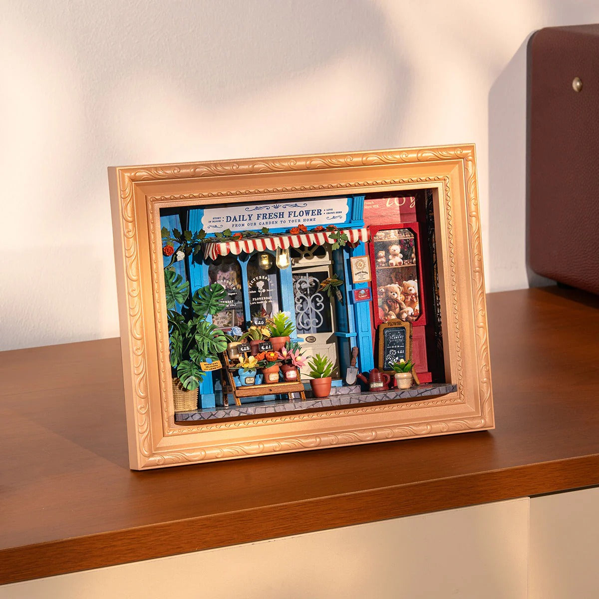 Rolife Daily Fresh Flower DP003 framed flower shop model displayed on a table with warm home lighting