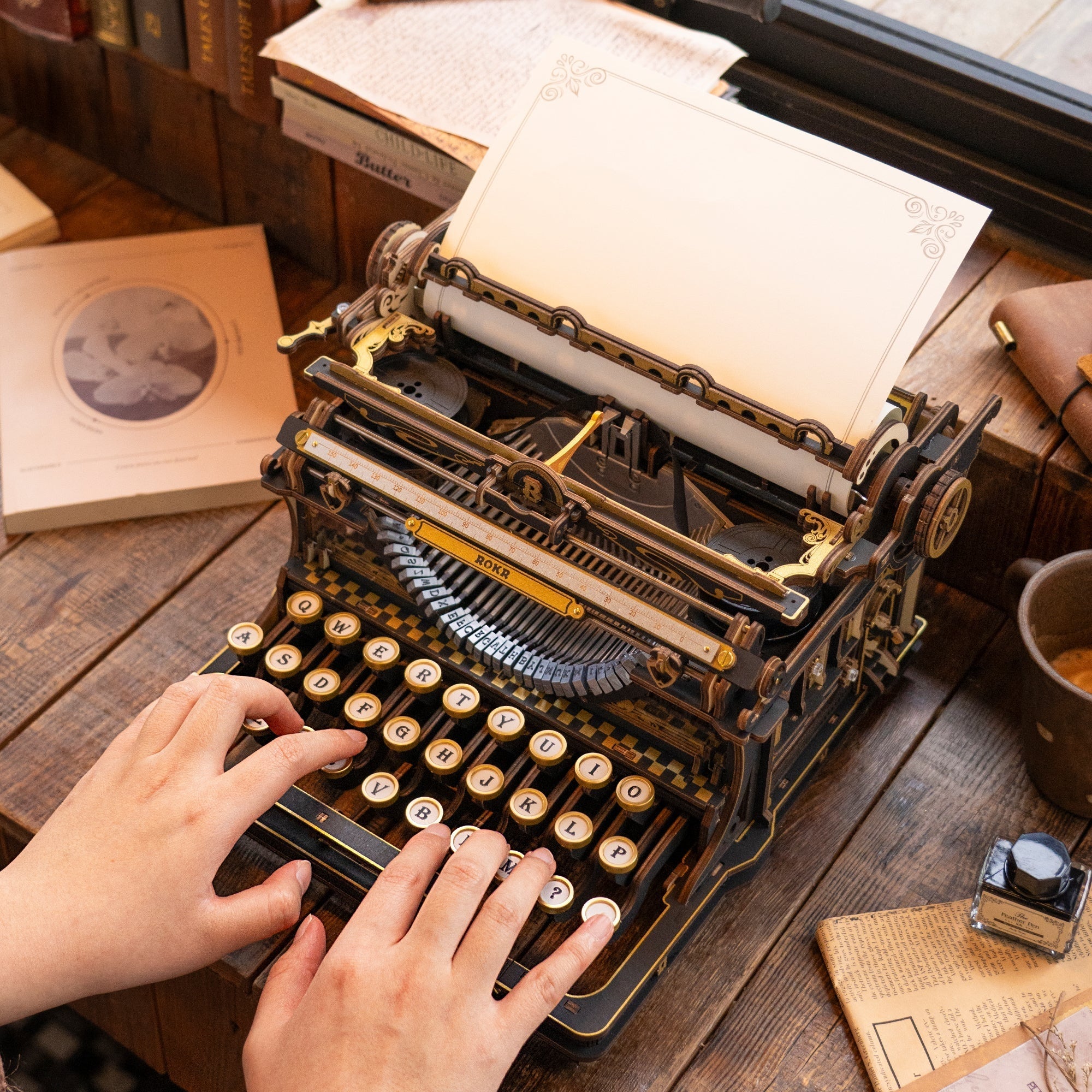 ROKR Mechanical Typewriter LK703B lifestyle scene showing hands typing on the assembled model