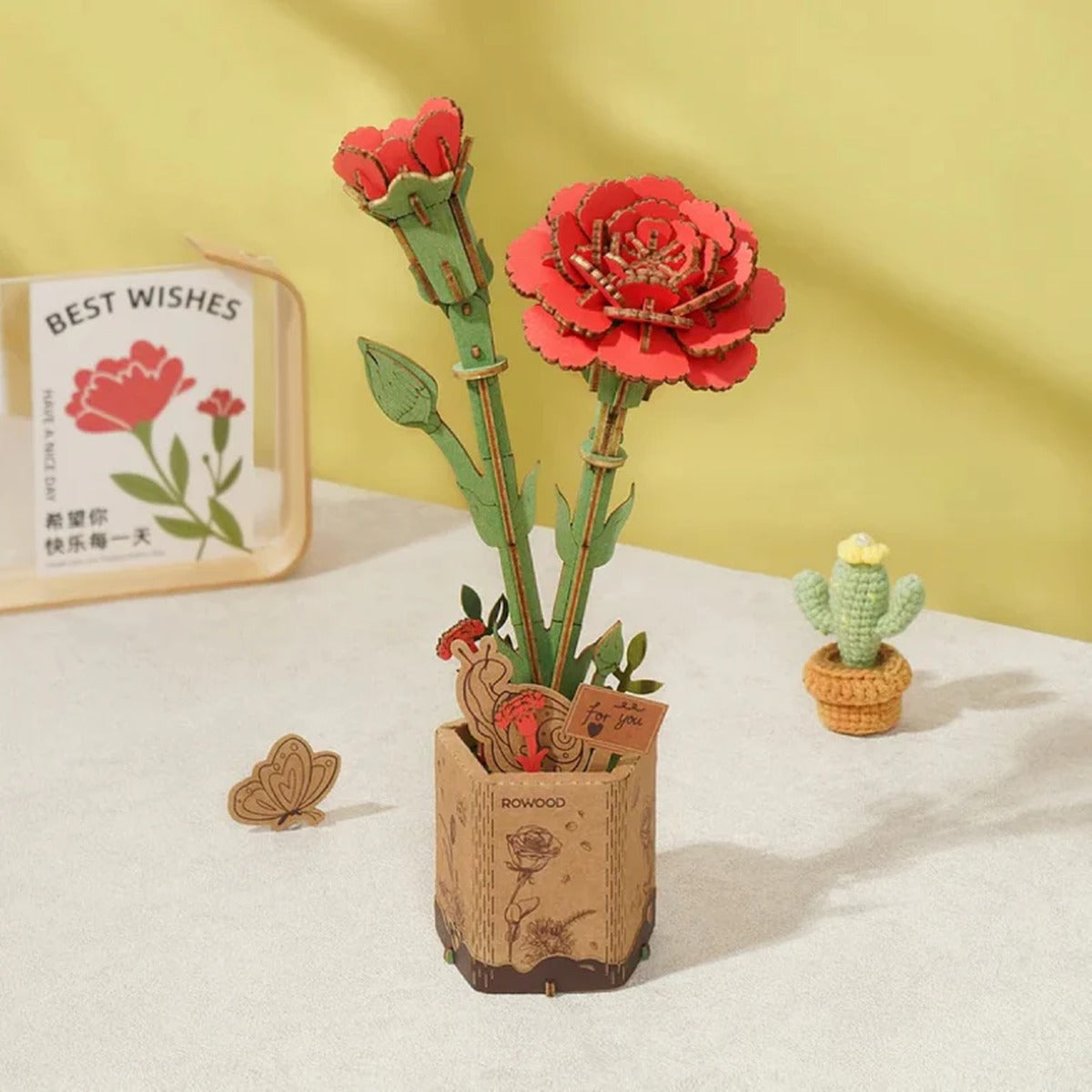 Rowood Red Carnation TW052 displayed as a long-lasting wooden flower decoration on a tabletop.