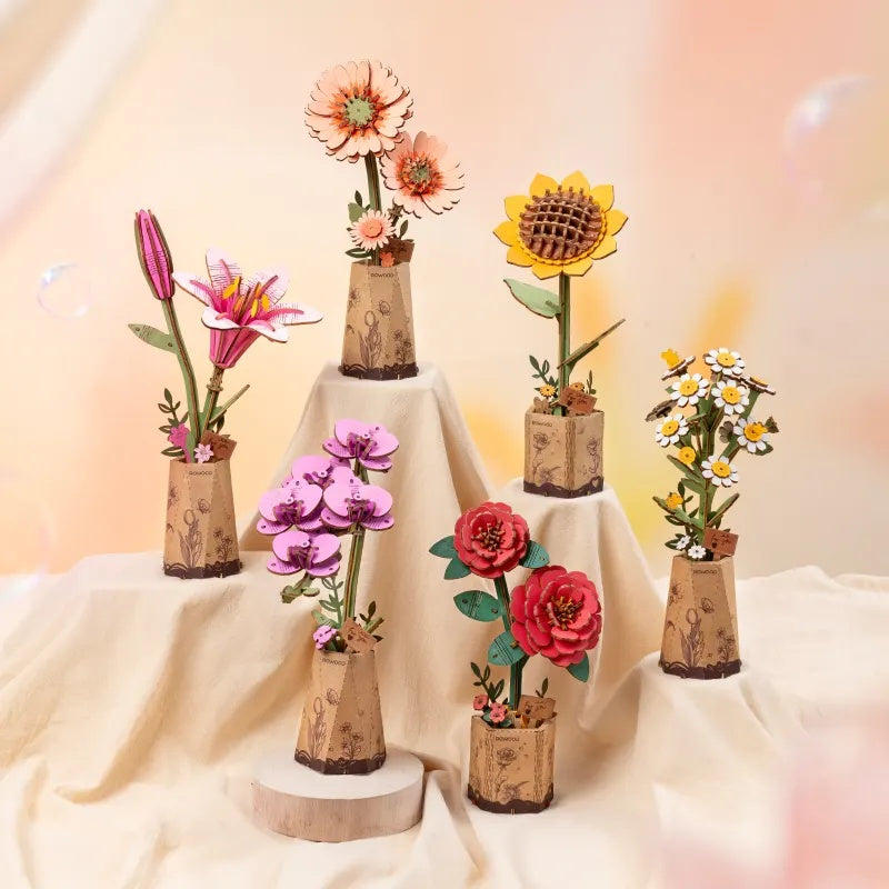 Rowood Light Orange Gerbera Daisy TW111 shown with other Rowood wooden flower kits in a mixed flower collection display