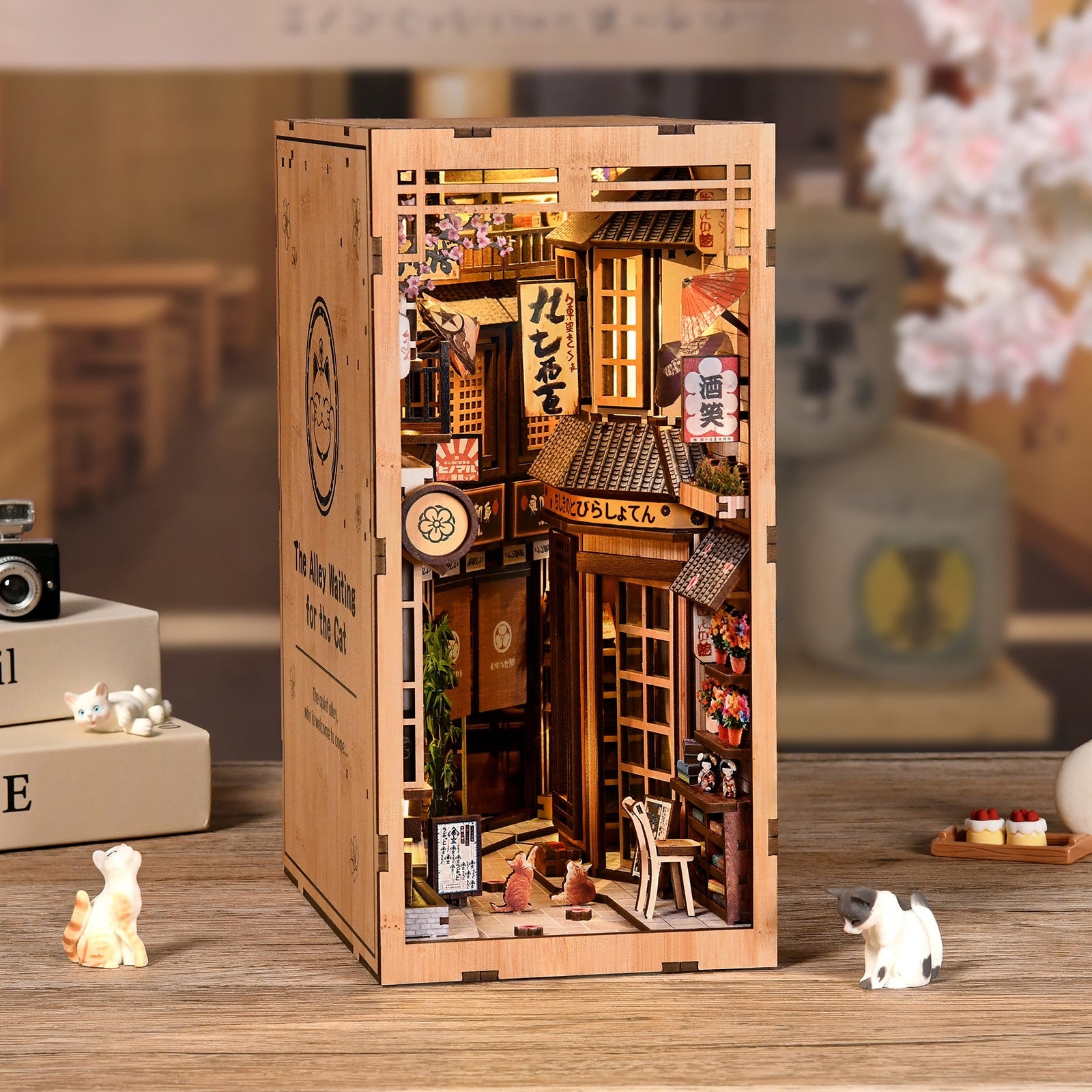 The Alley Waiting for the Cat DIY book nook kit displayed on a desk with cat-themed decor