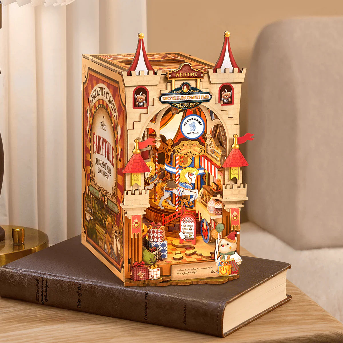 Rolife Tipsy Restaurant TGB17 DIY Miniature House Kit displayed on book with warm LED lights